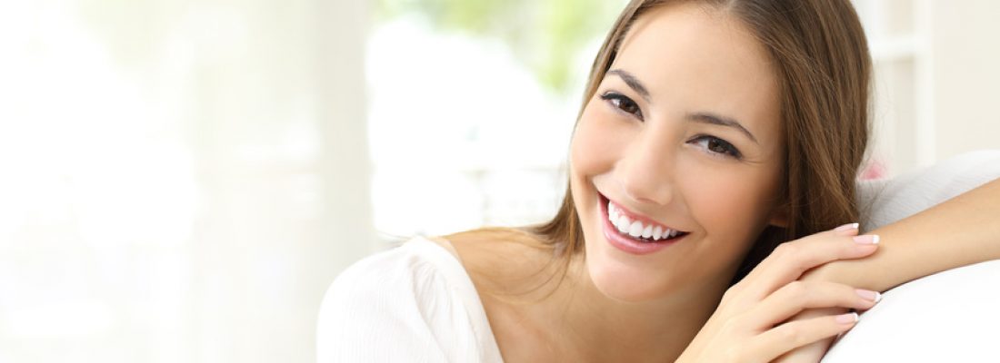 Beauty woman with white perfect smile looking at camera at home